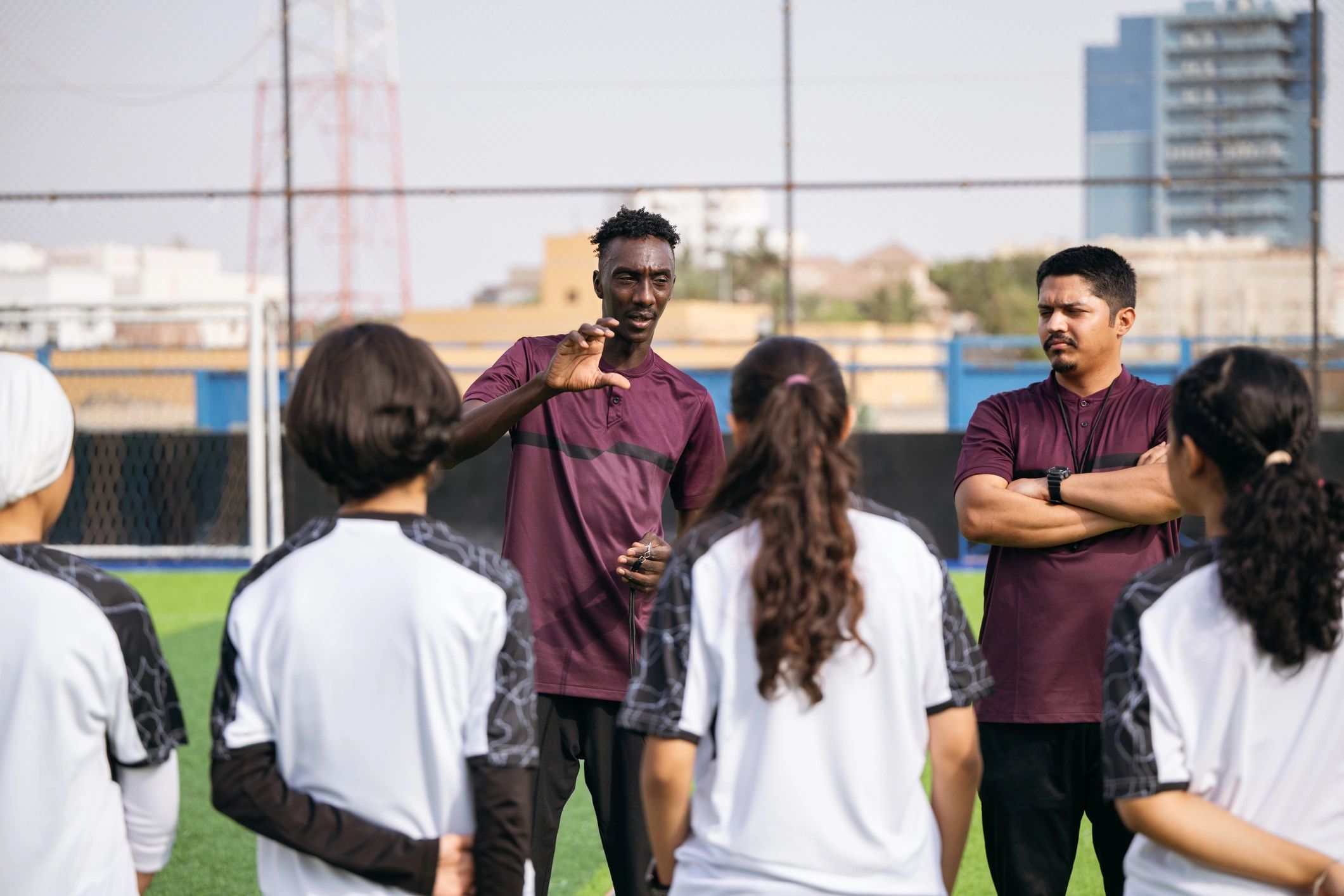 Coach giving instructions to a youth soccer team during training