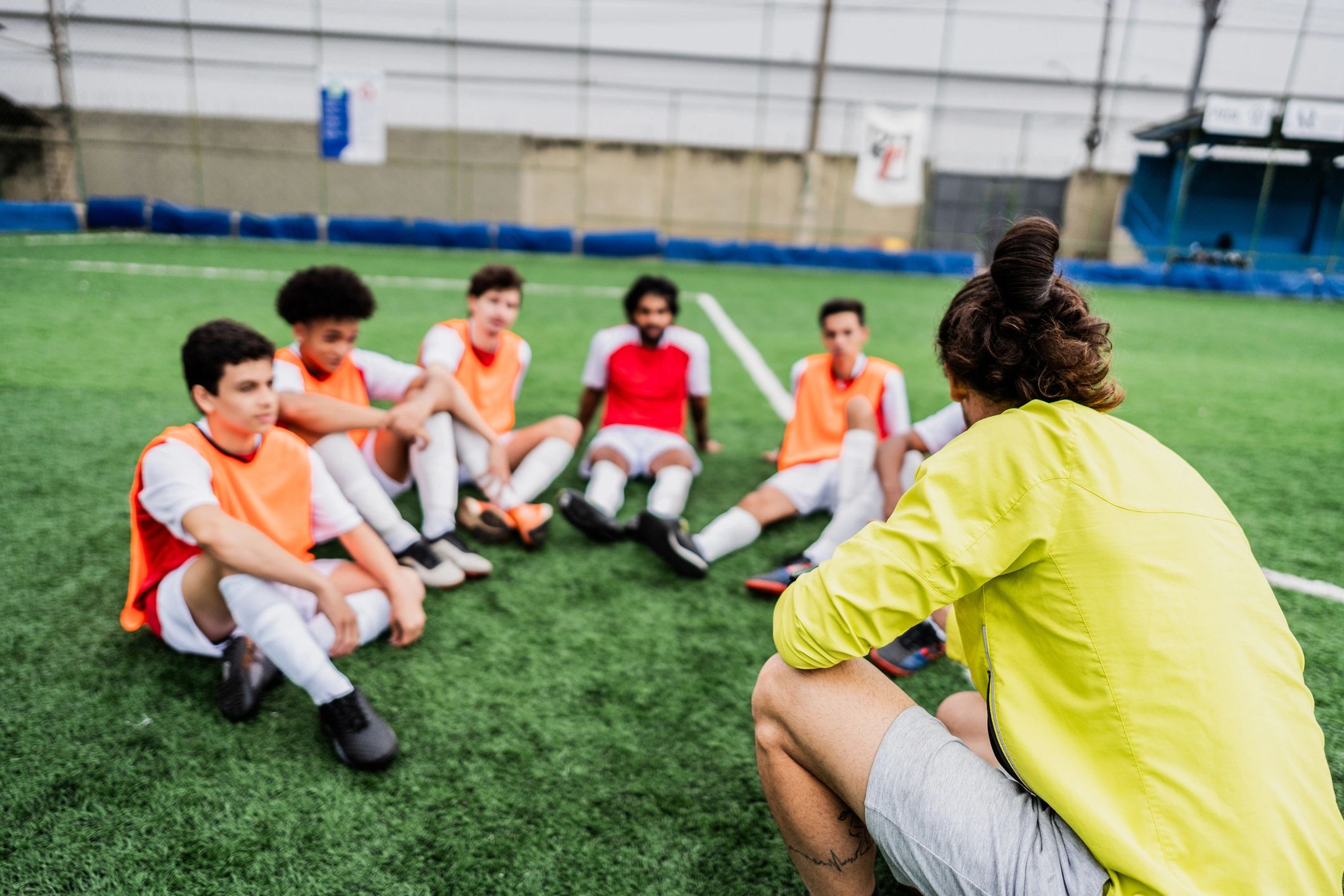 Coach speaking with players during a soccer training session