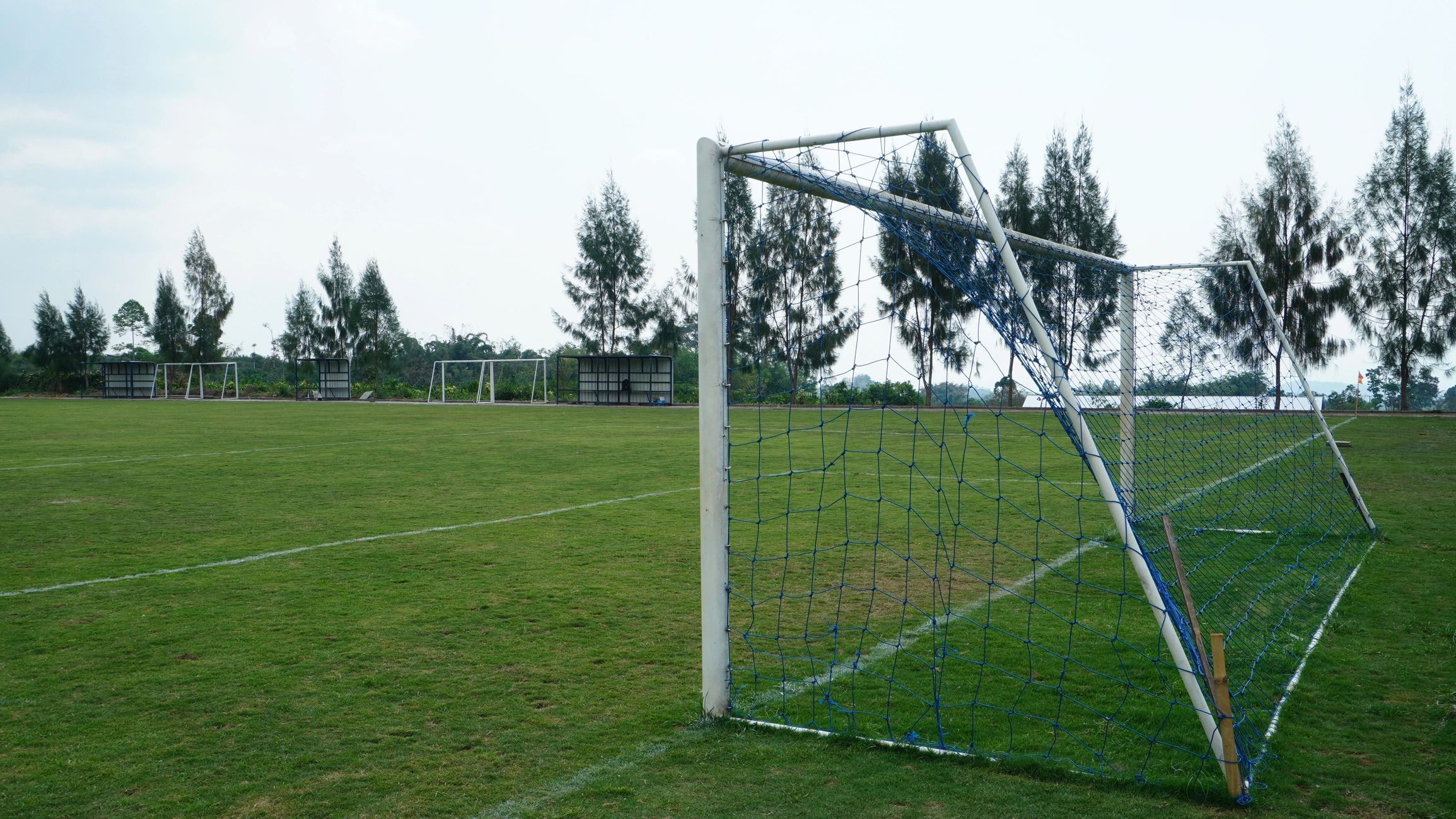 Soccer goal on an open training field at sunset