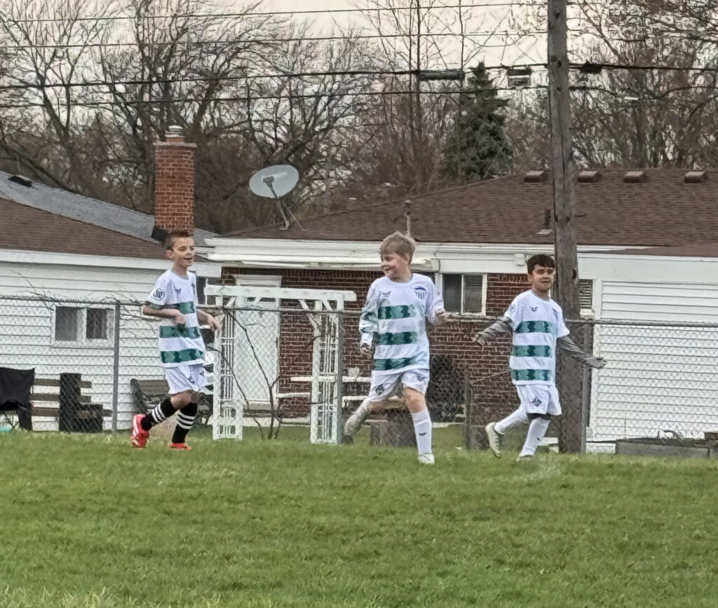 Coach working with youth soccer players